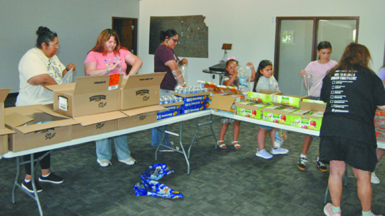 Girl Scouts donate cookies to food pantry, help assemble backpacks, coalition changes name