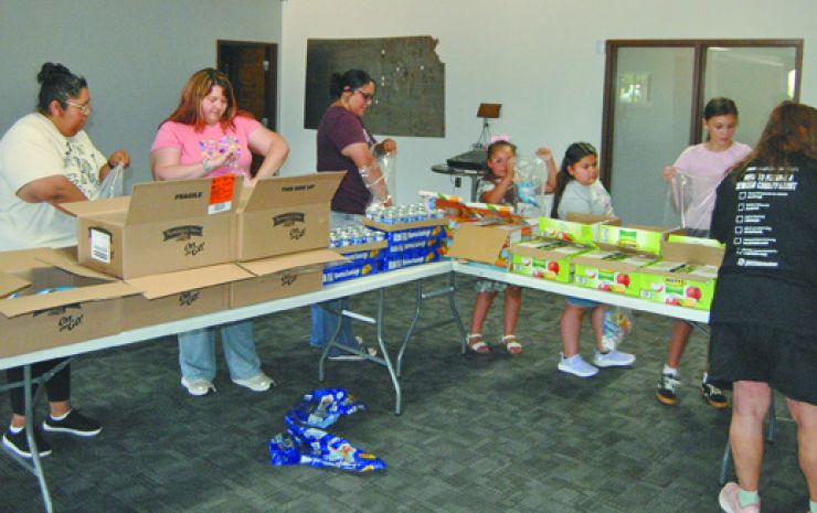 Girl Scouts donate cookies to food pantry, help assemble backpacks, coalition changes name